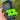Black container with green lids held by a hand against a blurred natural background