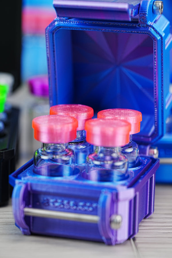 Where to buy peptide vials — open purple VialCase holding four glass peptide vials with pink rubber stoppers, organized in foam slots