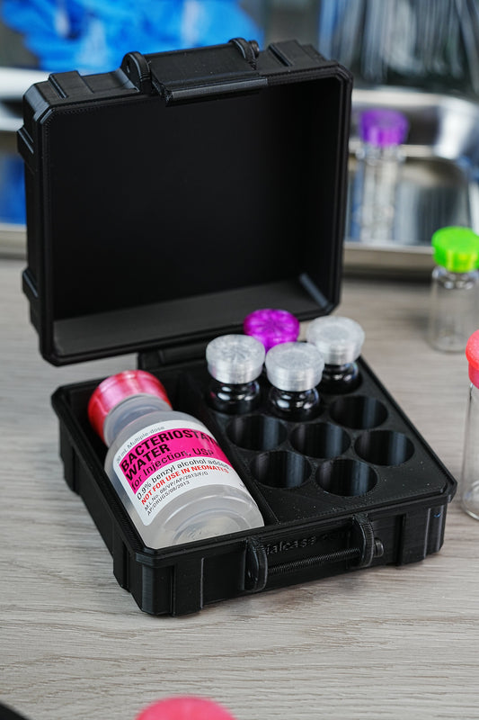 Bacteriostatic water sizes comparison — 30 mL Hospira BAC water bottle stored in a hard-shell VialCase alongside organized peptide vials in foam slots