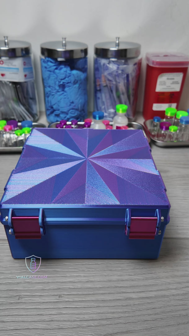 Large hard-shell case opened to show rows of small vials in organized slots, including a removable insert lifted using pinch handles.