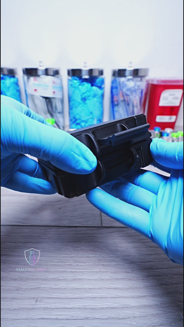 Black hard case opened to show organized vials with pink caps, including multiple small vials and one larger vial stored securely for travel.